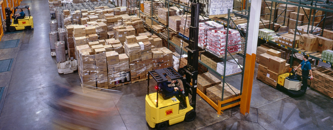 Motion blur of forklifts working in a restaurant distribution warehouse